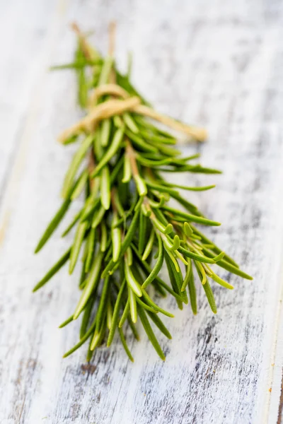Rosemary herbs on the wooden table — Stock Photo, Image