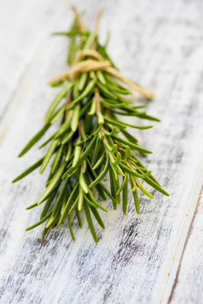 Rosemary herbs on the wooden table — Stock Photo, Image