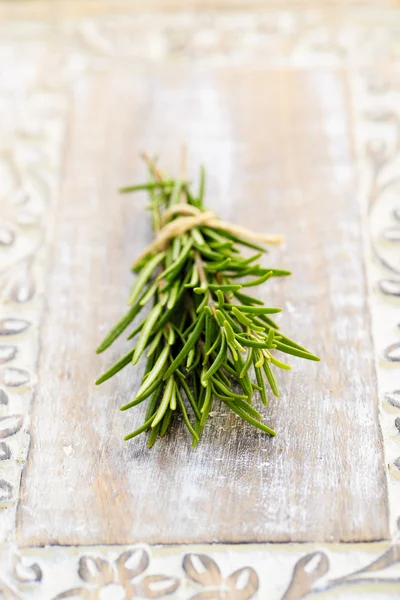 Rosemary herbs on the wooden table — Stock Photo, Image