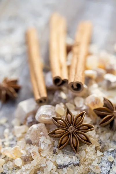 Cinnamon sticks and star anise on brown sugar — Stock Photo, Image