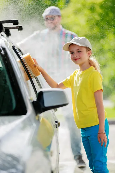 Carwash - young girl helping father to wash car — Stock Photo, Image