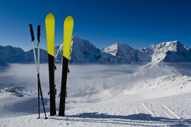 Ski, skiing, winter season , mountains and ski equipment on ski run clipart