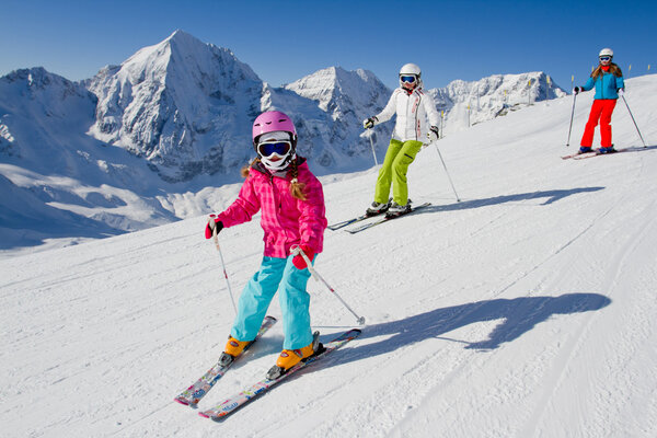 Skiing, winter, ski lesson - skiers on ski run