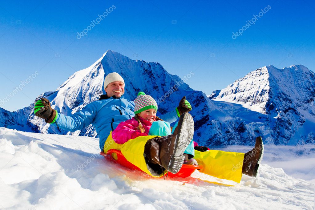 Winter fun, snow, family sledding at winter time