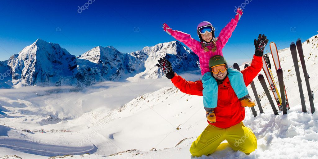 Ski, snow and winter fun - happy family playing in snow