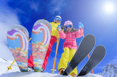 Ski, skiers, sun and winter fun - skiers enjoying ski vacation clipart