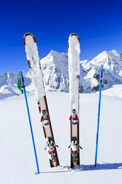 Skiing, winter season , mountains and ski equipments on ski run — Stock Photo, Image