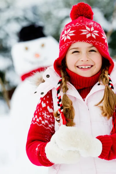 Winter, snowman - lovely girl has a fun in snow — Stock Photo, Image