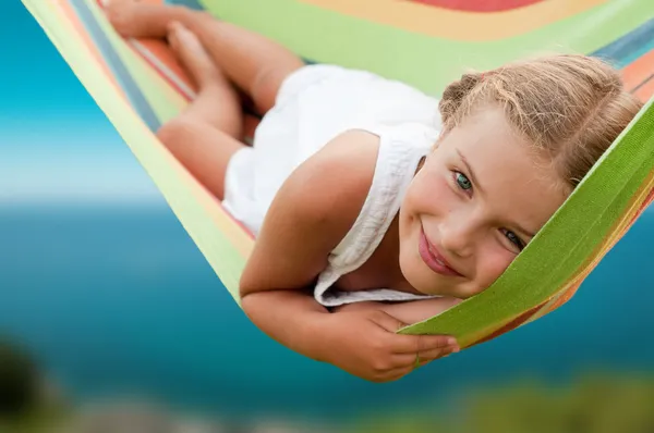 Summer vacation - lovely girl in colorful hammock — Stock Photo, Image