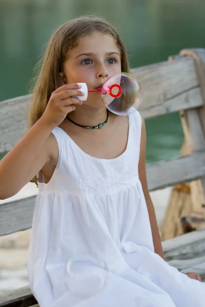 Sommerfreude, Seifenblasen - schönes Mädchen, das Blasen pustet — Stockfoto