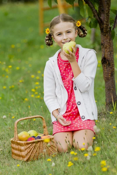 Gardening, orchard - lovely girl is eating ripe pear — Stock Photo, Image