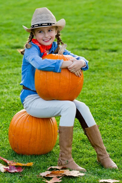 La cosecha de las calabazas, el otoño en el jardín - la muchacha encantadora y las calabazas grandes —  Fotos de Stock