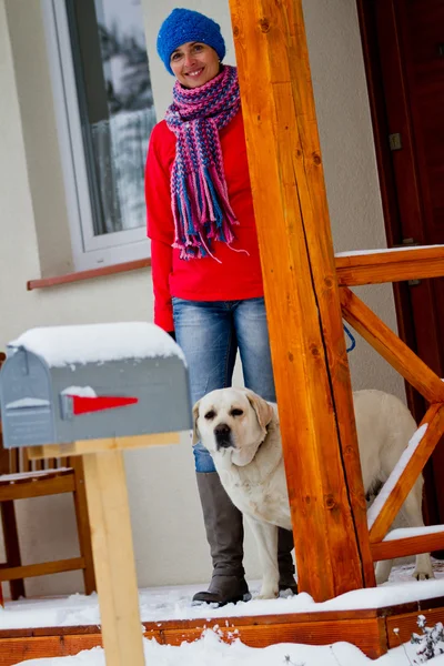 Winter walk with dog - Portrait of woman with dog in front of the house — Stock Photo, Image