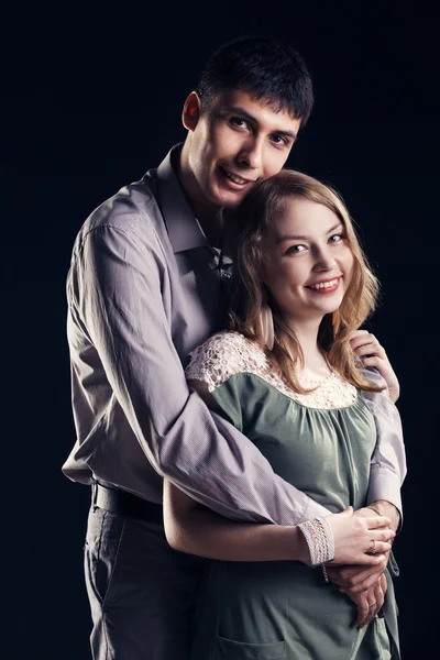 Man embracing his love. Dark background — Stock Photo, Image