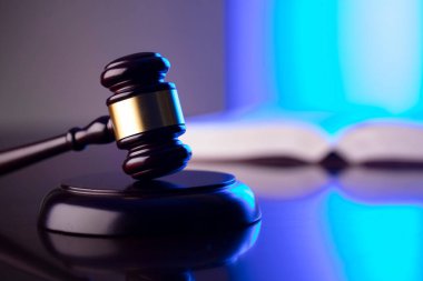 Hukuk kavramı. Gavel, avukatlık bürosunda heykel ve hukuk kuralları var. Bluelight arkaplanı.
