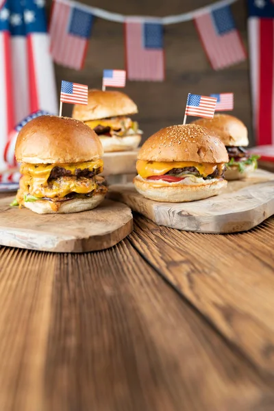 4 Temmuz kutlamaları. Amerikan bayrağı ve madalyaları. Köy ahşap masada hamburgerler.