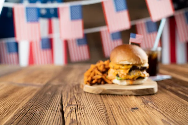 4 Temmuz kutlamaları. Amerikan bayrağı ve madalyaları. Köy ahşap masada hamburgerler.