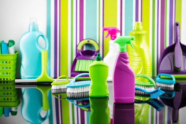 House  and office cleaning products. Colorful cleaning kit on striped color background.
