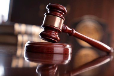 Law theme - judge office. Gavel, legal books and Themis  on the judge desk. 