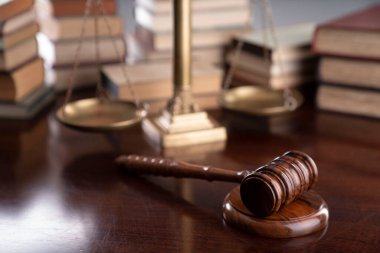 Law theme - judge office. Gavel, legal books and Themis  on the judge desk. 