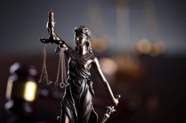  Law and justice concept. Law symbols composition. Themis sculpture and judges gavel on gray background.