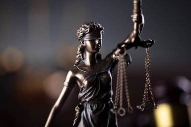  Law and justice concept. Law symbols composition. Themis sculpture and judges gavel on gray background.