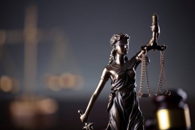  Law and justice concept. Law symbols composition. Themis sculpture and judges gavel on gray background.