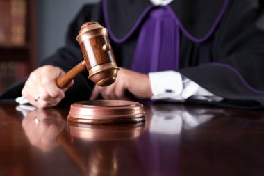 Judge in the office. Judge with the wooden gavel in his hand. Law and justice theme.
