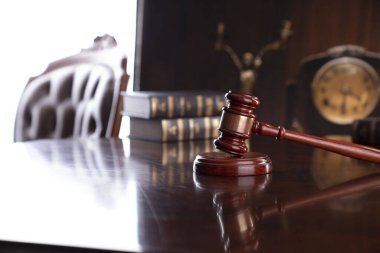 Law theme - judge office. Gavel and legal books on the judge desk. 