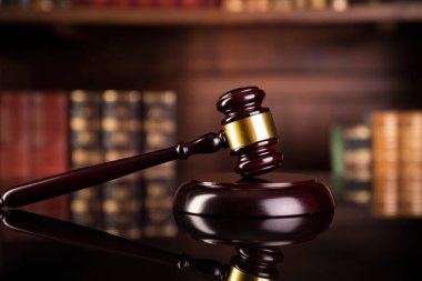 Law theme - judge office. Gavel and legal books on the judge desk. 