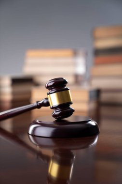 Law theme - judge office. Gavel and legal books on the judge desk. 