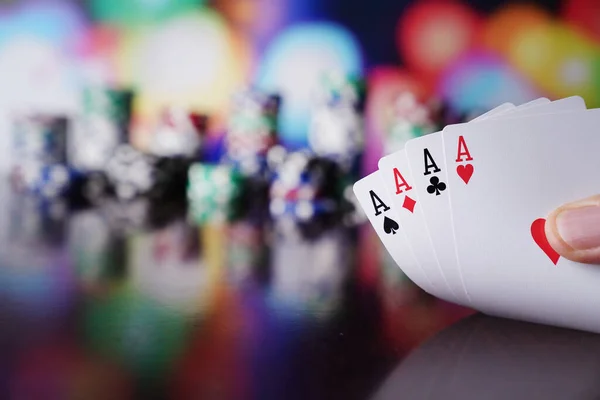 Casino theme.  Gambling games. Dices, cards and poker chips on a colorful bokeh background.