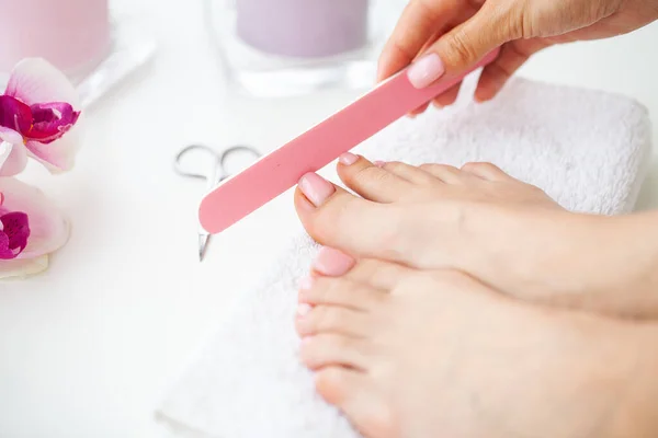 Closeup of beautiful woman legs getting pedicure at home — Zdjęcie stockowe