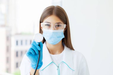 Doctor at hospital wearing medical mask to protect against coronavirus