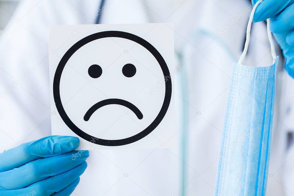 Doctor Holding a Cards With Symbol Sad Smile