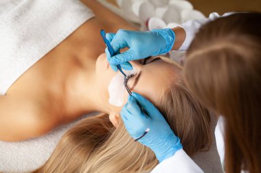 Kirpik Uzatma Prosedürü, kadın kirpiklerini uzatan profesyonel stilist