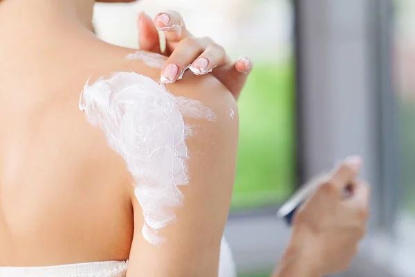 Schoonheidsvrouw met moisturizer concept in de badkamer — Stockfoto