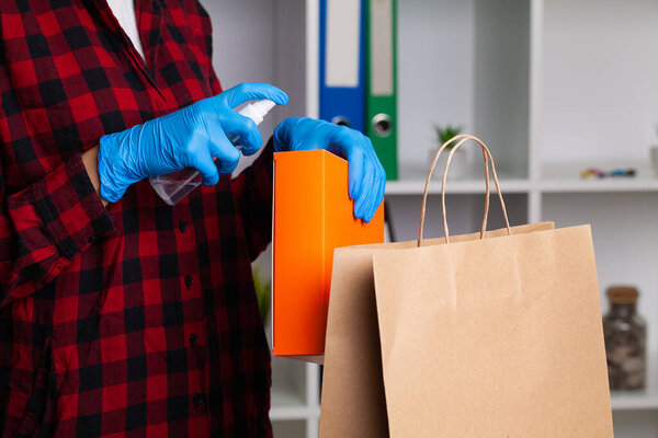 A woman disinfects parcels before unpacking them at home to avoid the possibility of being infected with COVID-19.