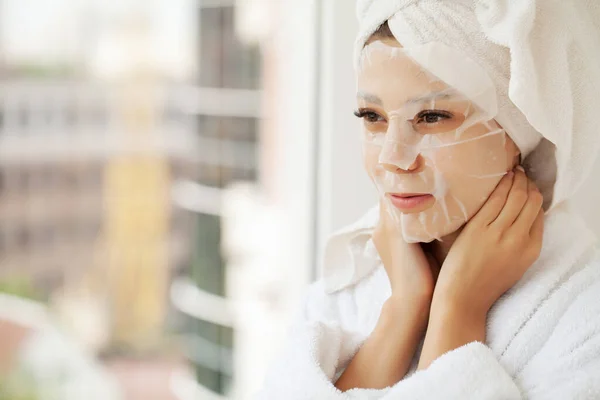 Young woman with cloth mask at spa salon.