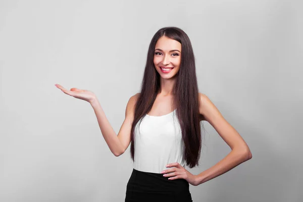 Lächelnde Geschäftsfrau Zeigt Nach Oben Und Blickt Vor Grauem Hintergrund — Stockfoto
