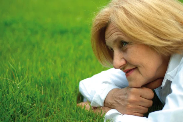 Beautiful Caucasian elderly woman lying — Stock Photo, Image