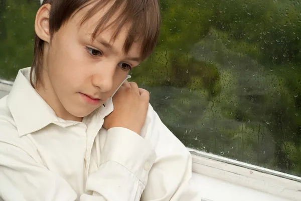 Pensive boy sitting at home — Stock Photo, Image
