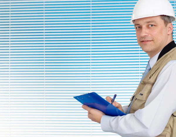 Intelligent man working in the construction helmet — Stock Photo, Image