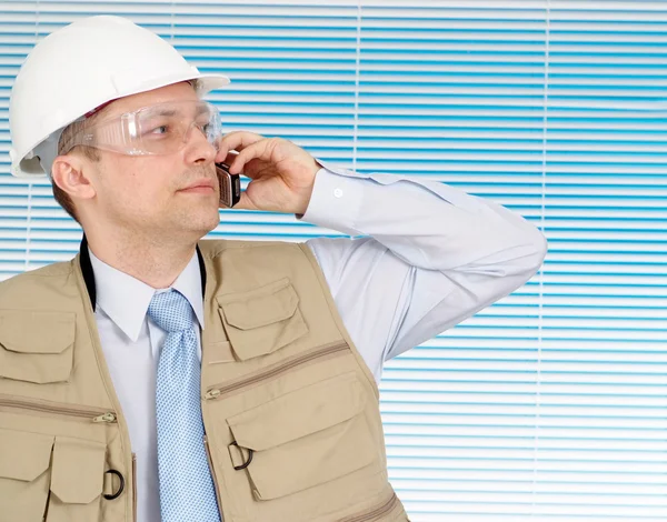 Hablando macho trabajando en el casco de construcción — Foto de Stock