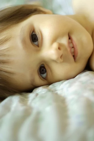 Adorable little girl in bed — Stock Photo, Image