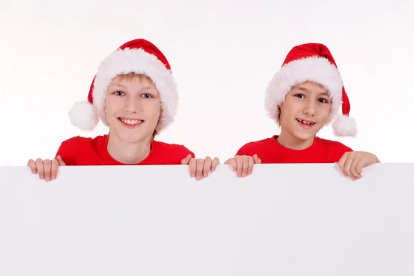 Santa kids with board — Stock Photo, Image