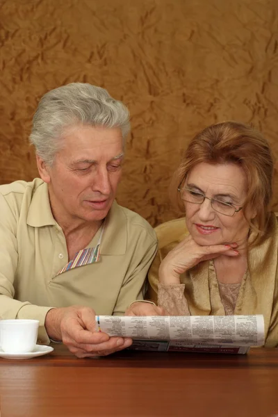 Beautiful Caucasian senior couple sitting at a table — Stock Photo, Image