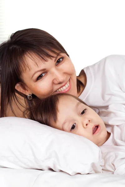 A beautiful pretty Caucasian mother with her daughter lying — Stock Photo, Image