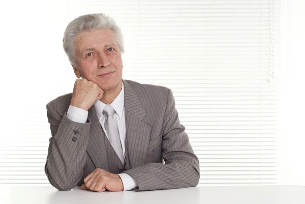 Older businessman sitting — Stock Photo, Image