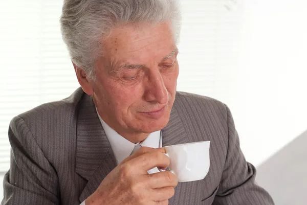 Nice an elderly man sits — Stock Photo, Image